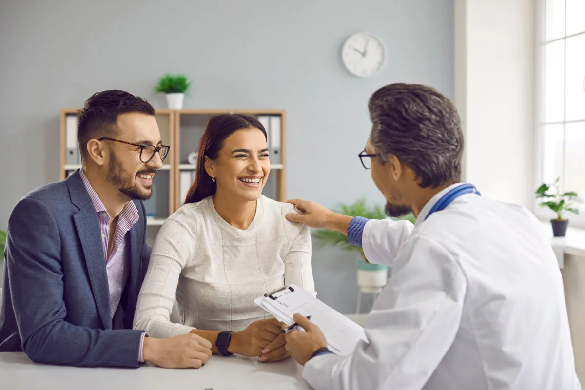 Clinician consulting with a smiling couple